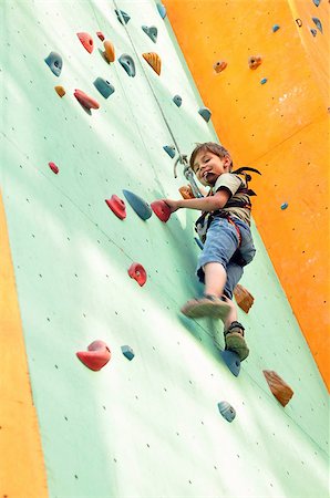 smiling elementary child climbing up the wall Photographie de stock - Aubaine LD & Abonnement, Code: 400-07040714