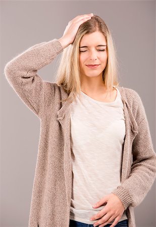Beautiful blonde woman in pain with a big headache Stock Photo - Budget Royalty-Free & Subscription, Code: 400-07042582