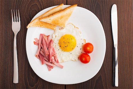 simsearch:400-07036577,k - Fried egg with toasts, ham and cherry tomato on a plate Stock Photo - Budget Royalty-Free & Subscription, Code: 400-07042638