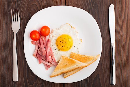 simsearch:400-07036577,k - Fried egg with toasts, ham and cherry tomato on a plate Stock Photo - Budget Royalty-Free & Subscription, Code: 400-07042642
