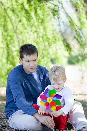 simsearch:400-07715953,k - happy father and his cute son with a pinwheel spending time together at the park Stock Photo - Budget Royalty-Free & Subscription, Code: 400-07043378