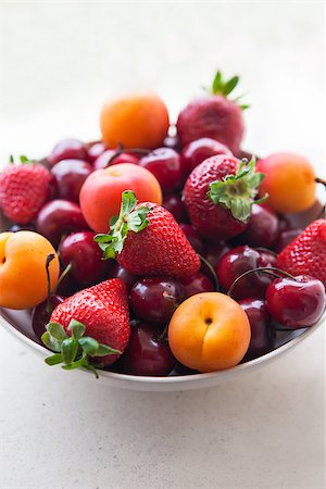 simsearch:400-07667203,k - Assorted colorful fresh summer berries and fruits - apricots, cherries and strawberries in the bowl on the stone table Stock Photo - Budget Royalty-Free & Subscription, Code: 400-07043961
