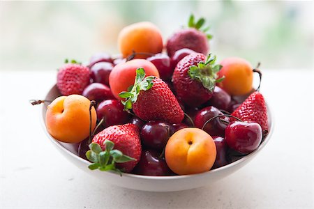 simsearch:400-07667203,k - Assorted colorful fresh summer berries and fruits - apricots, cherries and strawberries in the bowl on the stone table Stock Photo - Budget Royalty-Free & Subscription, Code: 400-07043962