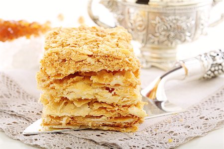 puff - Silver blade with cake of puff pastry on a linen napkin. Stock Photo - Budget Royalty-Free & Subscription, Code: 400-07054175