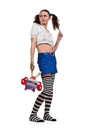 girl in striped socks, mini skirt with a toy and Pigtails Stockbilder - Microstock & Abonnement, Bildnummer: 400-07054884