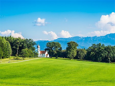 Typical chapel on grean meadow with alps and trees in Bavaria Stock Photo - Budget Royalty-Free & Subscription, Code: 400-07055370