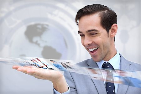 simsearch:695-05771557,k - Happy businessman looking at a picture stream on map background Stock Photo - Budget Royalty-Free & Subscription, Code: 400-07056996
