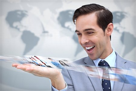 simsearch:695-05771557,k - Pleased businessman looking at a picture stream on map background Stock Photo - Budget Royalty-Free & Subscription, Code: 400-07056997