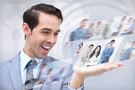 simsearch:695-05771557,k - Joyful businessman looking at pictures on map background Stock Photo - Budget Royalty-Free & Subscription, Code: 400-07056999