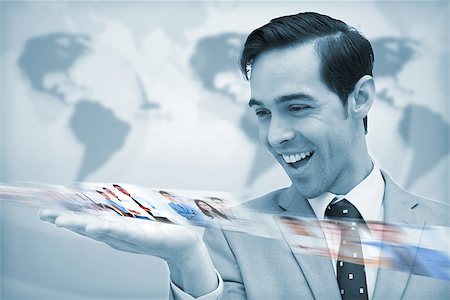 simsearch:695-05771557,k - Delighted businessman looking at a picture stream on map background Stock Photo - Budget Royalty-Free & Subscription, Code: 400-07057000