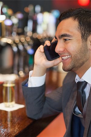 simsearch:400-07141016,k - Smiling businessman on the phone having a drink in a classy bar Stockbilder - Microstock & Abonnement, Bildnummer: 400-07057074