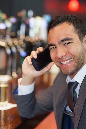 simsearch:400-07141019,k - Happy businessman on the phone having a drink in a classy bar Stockbilder - Microstock & Abonnement, Bildnummer: 400-07057075
