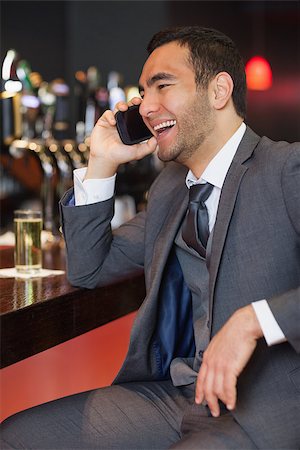 simsearch:400-07141016,k - Cheerful businessman on the phone having a drink in a classy bar Stockbilder - Microstock & Abonnement, Bildnummer: 400-07057073