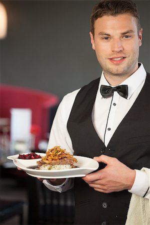 simsearch:400-07057171,k - Handsome waiter serving appetizing duck dish in classy restaurant Foto de stock - Super Valor sin royalties y Suscripción, Código: 400-07057159