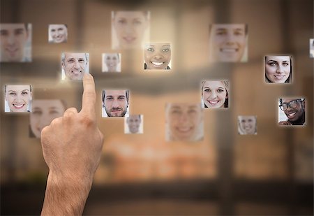 Finger selecting futuristic interface showing faces Stock Photo - Budget Royalty-Free & Subscription, Code: 400-07057210
