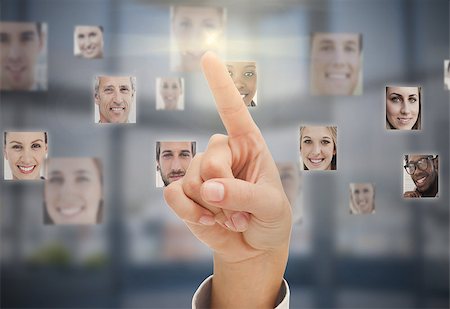 Finger touching futuristic interface showing human faces Stock Photo - Budget Royalty-Free & Subscription, Code: 400-07057211