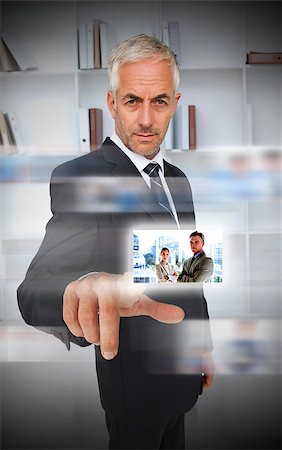 digital experience - Experienced businessman using futuristic interface showing partners Stock Photo - Budget Royalty-Free & Subscription, Code: 400-07057236