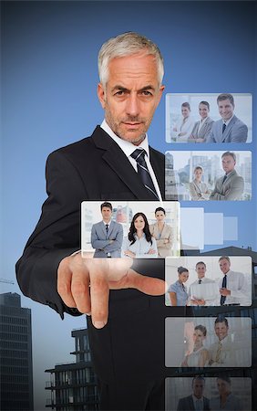digital experience - Experienced classy businessman using digital interface showing coworkers Stock Photo - Budget Royalty-Free & Subscription, Code: 400-07057237