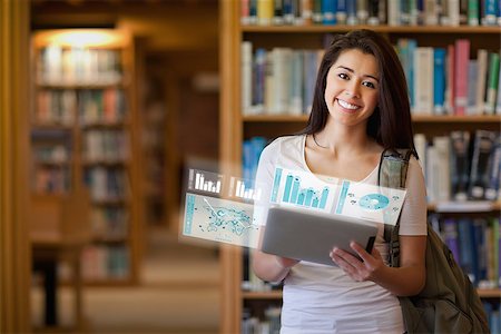 simsearch:400-07057823,k - Smiling student working on her futuristic tablet in university library Foto de stock - Super Valor sin royalties y Suscripción, Código: 400-07057797