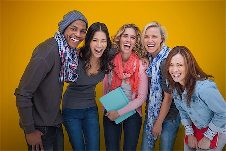 Cheerful group of friends laughing together on yellow background Stock Photo - Budget Royalty-Free & Subscription, Code: 400-07057791