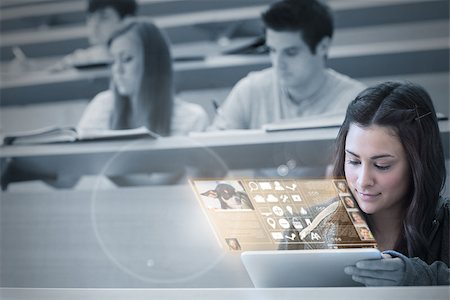 simsearch:400-07138128,k - Serious student working on her futuristic tablet in lecture hall Stock Photo - Budget Royalty-Free & Subscription, Code: 400-07057800
