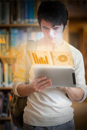 simsearch:400-07138128,k - Serious handsome student working on his futuristic tablet in university library Stock Photo - Budget Royalty-Free & Subscription, Code: 400-07057825
