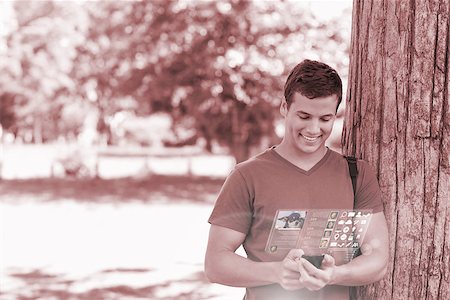 simsearch:400-07057823,k - Smiling handsome student using his digital phone in bright park Foto de stock - Super Valor sin royalties y Suscripción, Código: 400-07057883