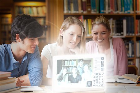 simsearch:400-07138128,k - Cheerful college friends watching photos on digital interface in university library Stock Photo - Budget Royalty-Free & Subscription, Code: 400-07057890