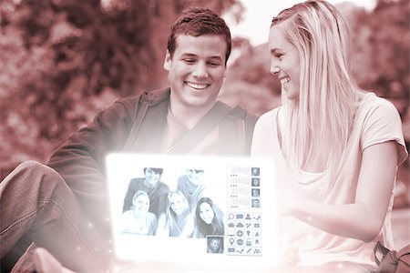 simsearch:400-07138128,k - Cheerful young couple watching photos together on digital interface in bright park Stock Photo - Budget Royalty-Free & Subscription, Code: 400-07057906