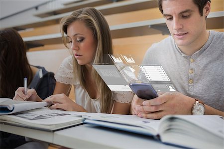 simsearch:400-07057823,k - Serious college student working on futuristic smartphone in lecture hall Foto de stock - Super Valor sin royalties y Suscripción, Código: 400-07057900