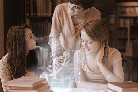 simsearch:400-07138128,k - Cheerful students working together with futuristic interface in university library Stock Photo - Budget Royalty-Free & Subscription, Code: 400-07057916
