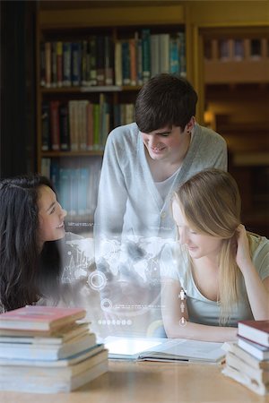 Happy students working together with futuristic interface in university library Stock Photo - Budget Royalty-Free & Subscription, Code: 400-07057917