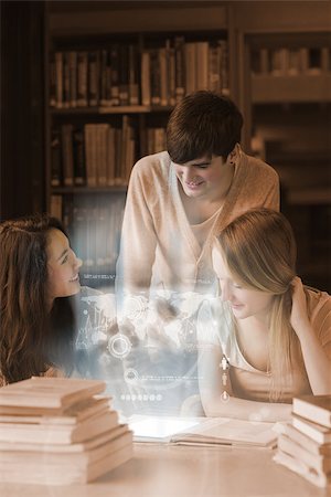 simsearch:400-07138128,k - Happy students working together on international trade with futuristic interface in university library Stock Photo - Budget Royalty-Free & Subscription, Code: 400-07057918