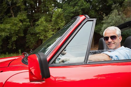 simsearch:400-07057982,k - Cheerful handsome man enjoying his red convertible on a bright day Foto de stock - Super Valor sin royalties y Suscripción, Código: 400-07057968