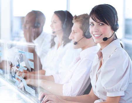 simsearch:400-07138128,k - Pretty call center worker using futuristic holographic interface smiling at camera in office Stock Photo - Budget Royalty-Free & Subscription, Code: 400-07057960