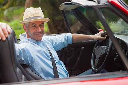 simsearch:400-07057982,k - Smiling handsome man posing in red convertible on a bright day Foto de stock - Super Valor sin royalties y Suscripción, Código: 400-07057973