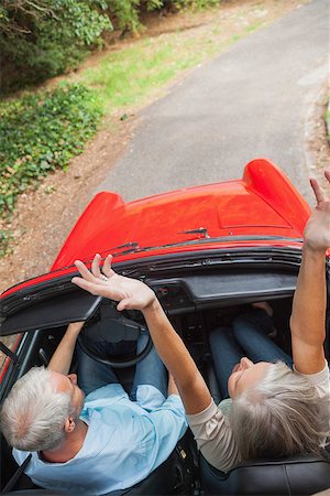 simsearch:400-07057982,k - Overhead view of happy mature couple going for a ride together in classy convertible Foto de stock - Super Valor sin royalties y Suscripción, Código: 400-07057989