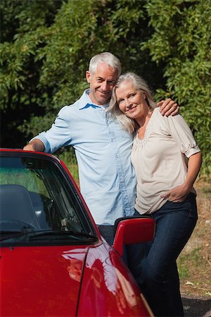 simsearch:400-07057982,k - Happy mature couple posing against their red cabriolet Foto de stock - Super Valor sin royalties y Suscripción, Código: 400-07058015