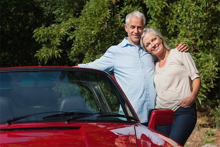 simsearch:400-07057982,k - Happy mature couple hugging by their red cabriolet on a sunny day Foto de stock - Super Valor sin royalties y Suscripción, Código: 400-07058016