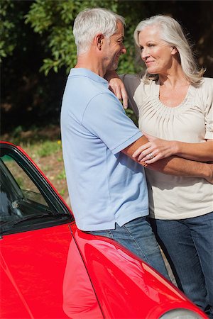 simsearch:400-07057982,k - Cheerful mature couple hugging against their red cabriolet on a sunny day Foto de stock - Super Valor sin royalties y Suscripción, Código: 400-07058029