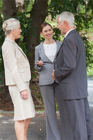 simsearch:693-06022167,k - Smiling business people talking together outside on a bright day Photographie de stock - Aubaine LD & Abonnement, Code: 400-07058096