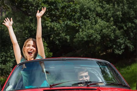 simsearch:400-07058112,k - Happy couple having fun in their red cabriolet on a sunny day Photographie de stock - Aubaine LD & Abonnement, Code: 400-07058127