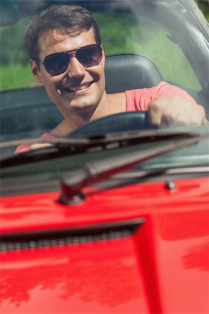 simsearch:400-07058116,k - Cheerful handsome man driving his cabriolet on a sunny day Stock Photo - Budget Royalty-Free & Subscription, Code: 400-07058132