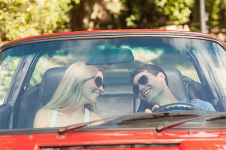 simsearch:400-07058112,k - Loving couple in their red cabriolet having a ride on sunny day Photographie de stock - Aubaine LD & Abonnement, Code: 400-07058165