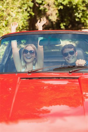 simsearch:400-07058112,k - Loving couple having fun in their red cabriolet on a sunny day Photographie de stock - Aubaine LD & Abonnement, Code: 400-07058166