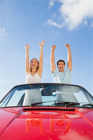 simsearch:400-07058116,k - Cheerful couple standing in red cabriolet on a sunny day Stock Photo - Budget Royalty-Free & Subscription, Code: 400-07058171
