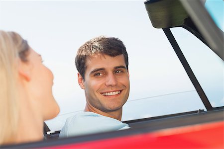 simsearch:400-07058116,k - Smiling man looking at his pretty girlfriend while driving his cabriolet Stock Photo - Budget Royalty-Free & Subscription, Code: 400-07058180