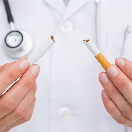 simsearch:400-06876304,k - Close up on doctor breaking cigarette on white background Stock Photo - Budget Royalty-Free & Subscription, Code: 400-07058376
