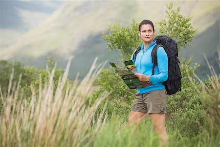 people on trail with map - Attractive female hiker with backpack holding a map in the countryside Stock Photo - Budget Royalty-Free & Subscription, Code: 400-07058461