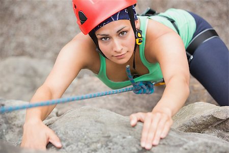simsearch:400-06956627,k - Focused girl climbing rock face looking up at camera Stock Photo - Budget Royalty-Free & Subscription, Code: 400-07058535